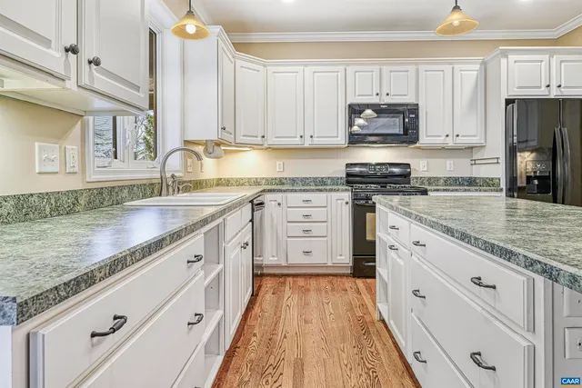 a bathroom with white bath tub and a window