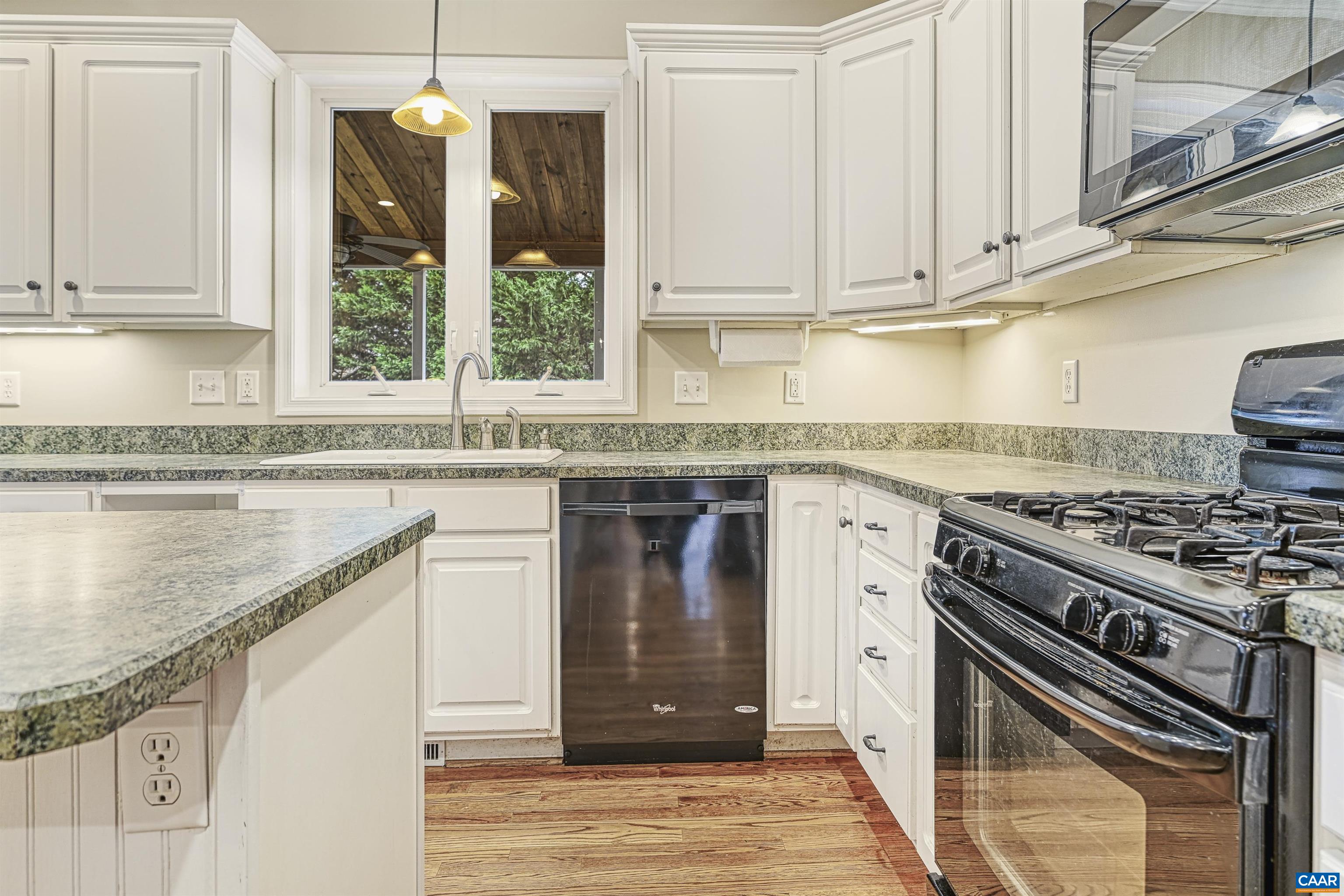 4885 Mechums River Road Charlottesville, VA 22901 - Photo 15 of 72 a kitchen with stainless steel appliances granite countertop a stove and a white cabinets