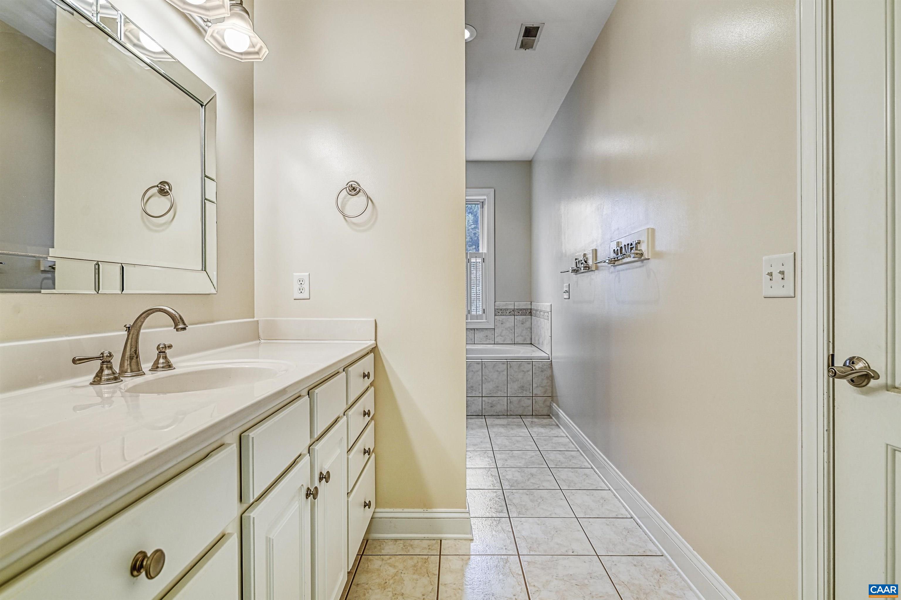 4885 Mechums River Road Charlottesville, VA 22901 - Photo 25 of 72 a bathroom with a sink and a mirror