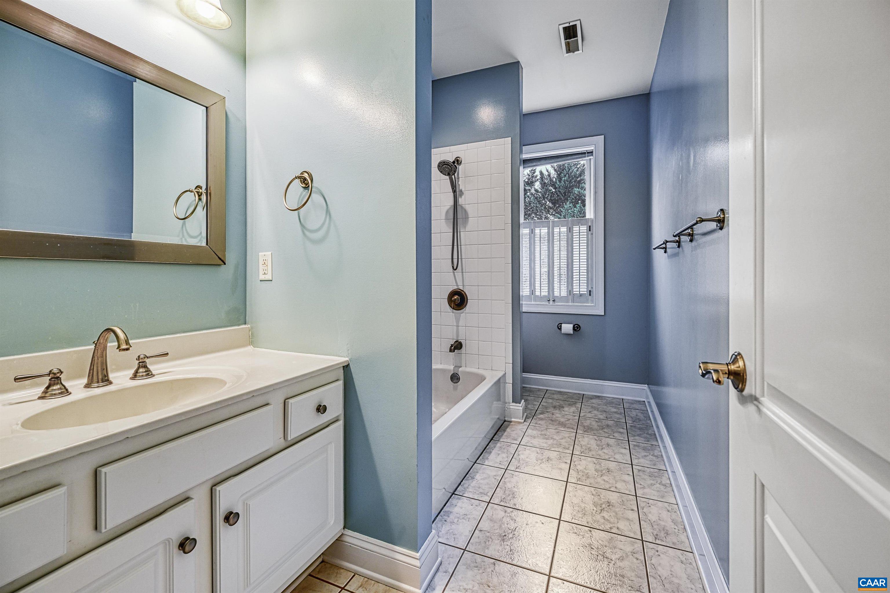 4885 Mechums River Road Charlottesville, VA 22901 - Photo 38 of 72 a bathroom with a sink a mirror and a shower