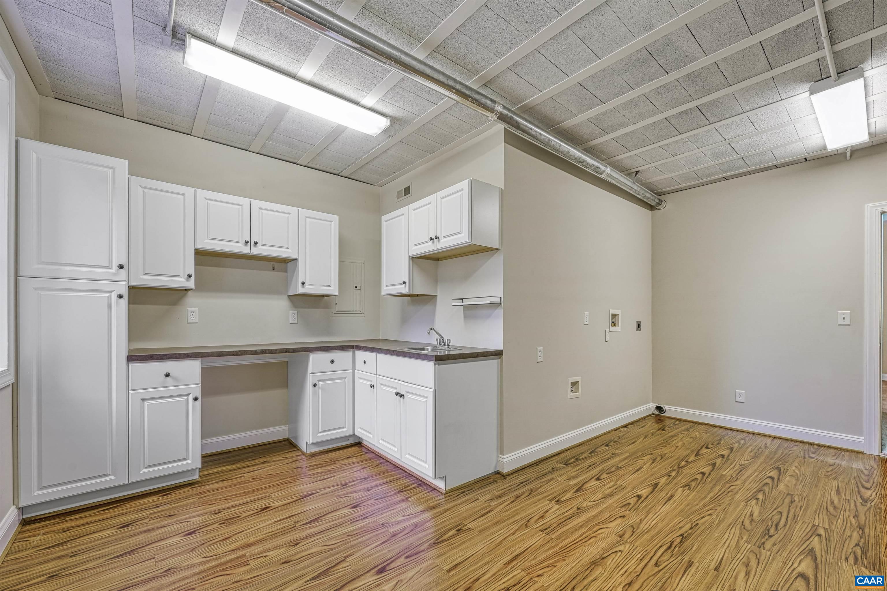4885 Mechums River Road Charlottesville, VA 22901 - Photo 47 of 72 a kitchen with stainless steel appliances granite countertop a sink and cabinets