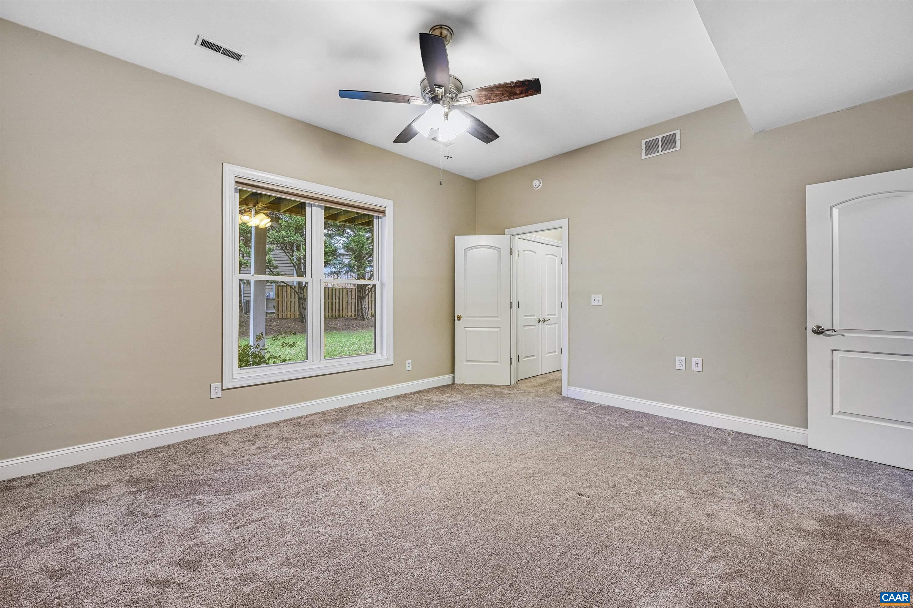 4885 Mechums River Road Charlottesville, VA 22901 - Photo 53 of 72 an empty room with windows and ceiling fan