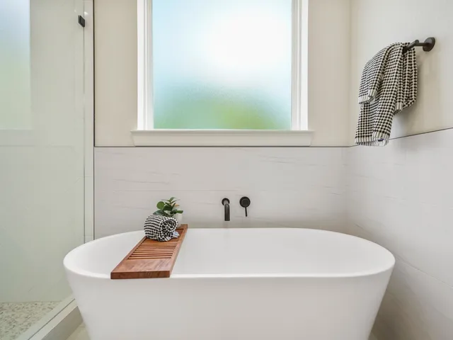 a white bath tub sitting next to a window