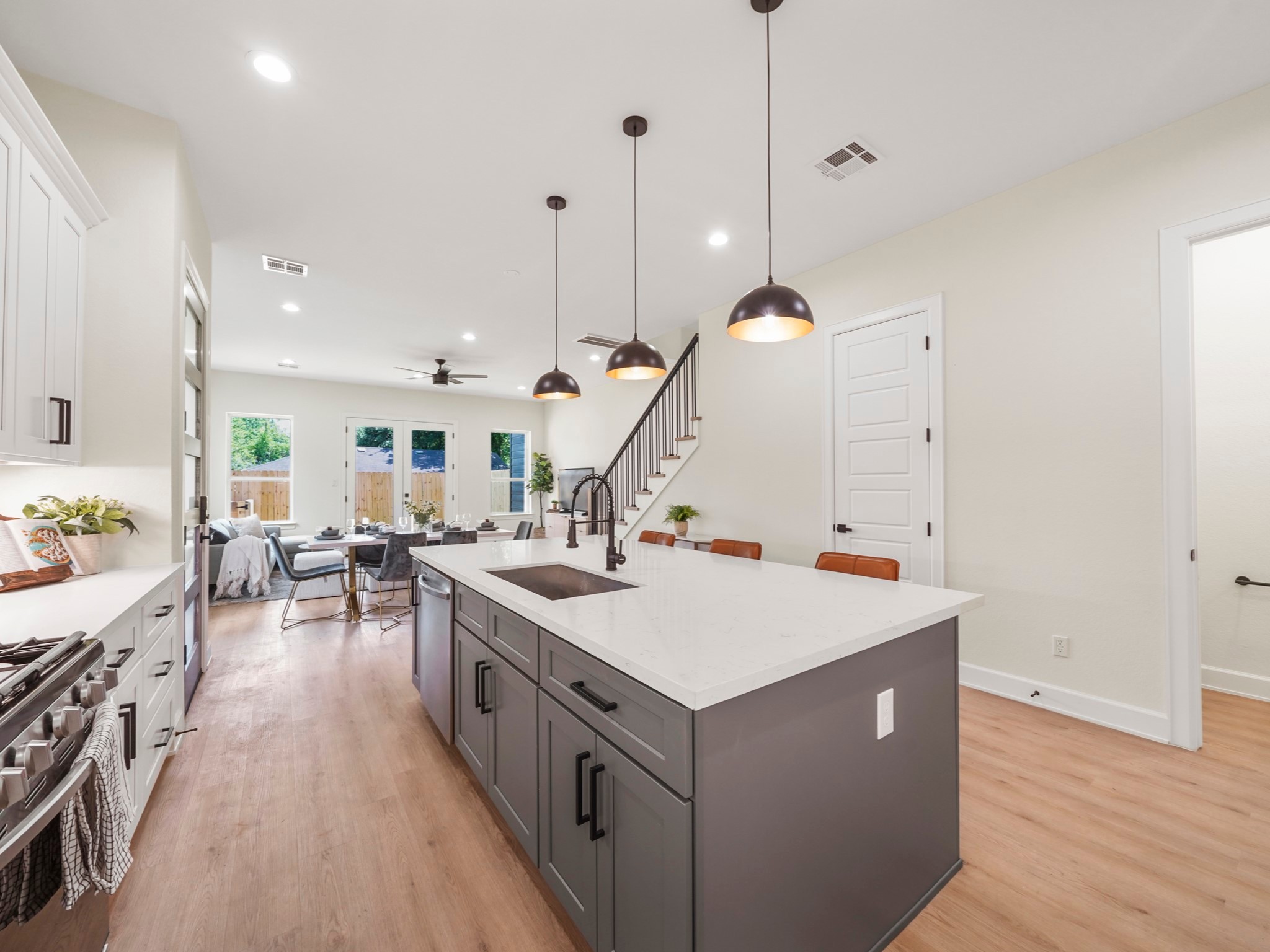 3548 Seabrook Street Houston, TX 77021 - Photo 5 of 19 a view of a kitchen with a sink a stove center island with wooden floor
