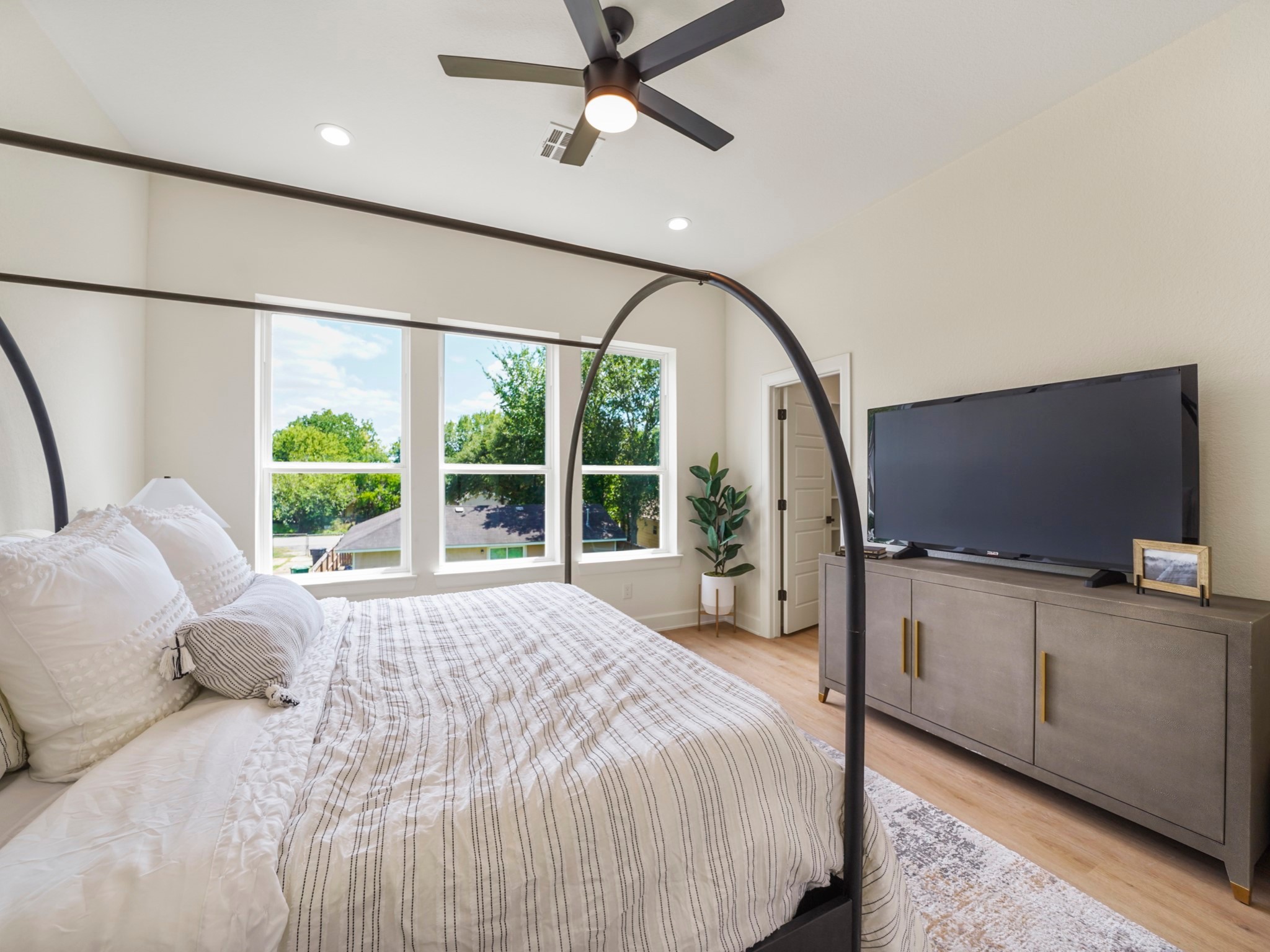 3548 Seabrook Street Houston, TX 77021 - Photo 10 of 19 a bedroom with a bed flat screen tv and a large window