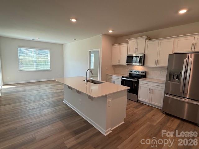 2315 Riggs Road Sherrills Ford, NC 28673 - Photo 7 of 17 a kitchen with stainless steel appliances a refrigerator a sink a stove a microwave and wooden floor