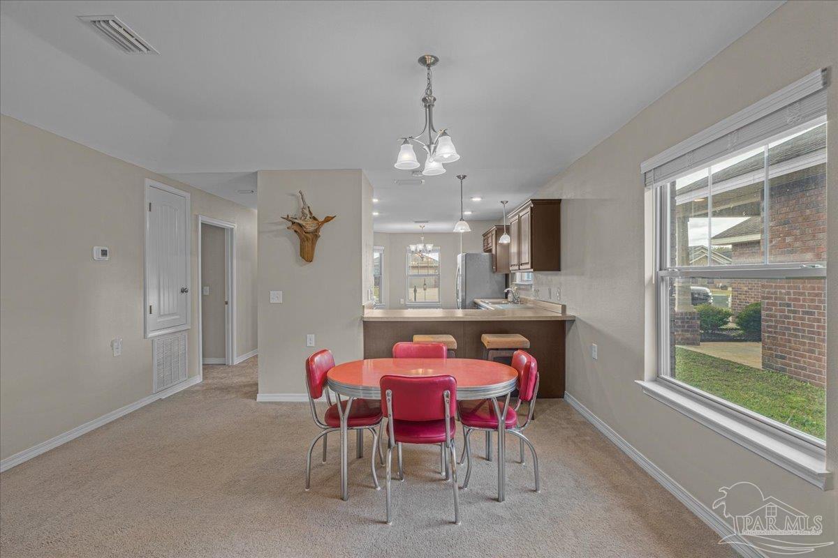 5797 Corkscrew Court Pace, FL 32571 - Photo 18 of 43 a dining room with furniture and window