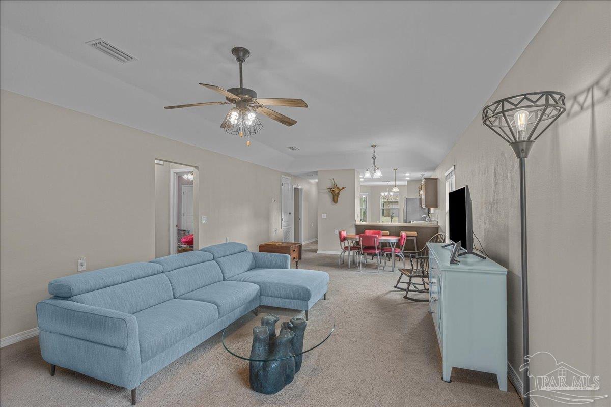 5797 Corkscrew Court Pace, FL 32571 - Photo 20 of 43 a living room with furniture and a flat screen tv
