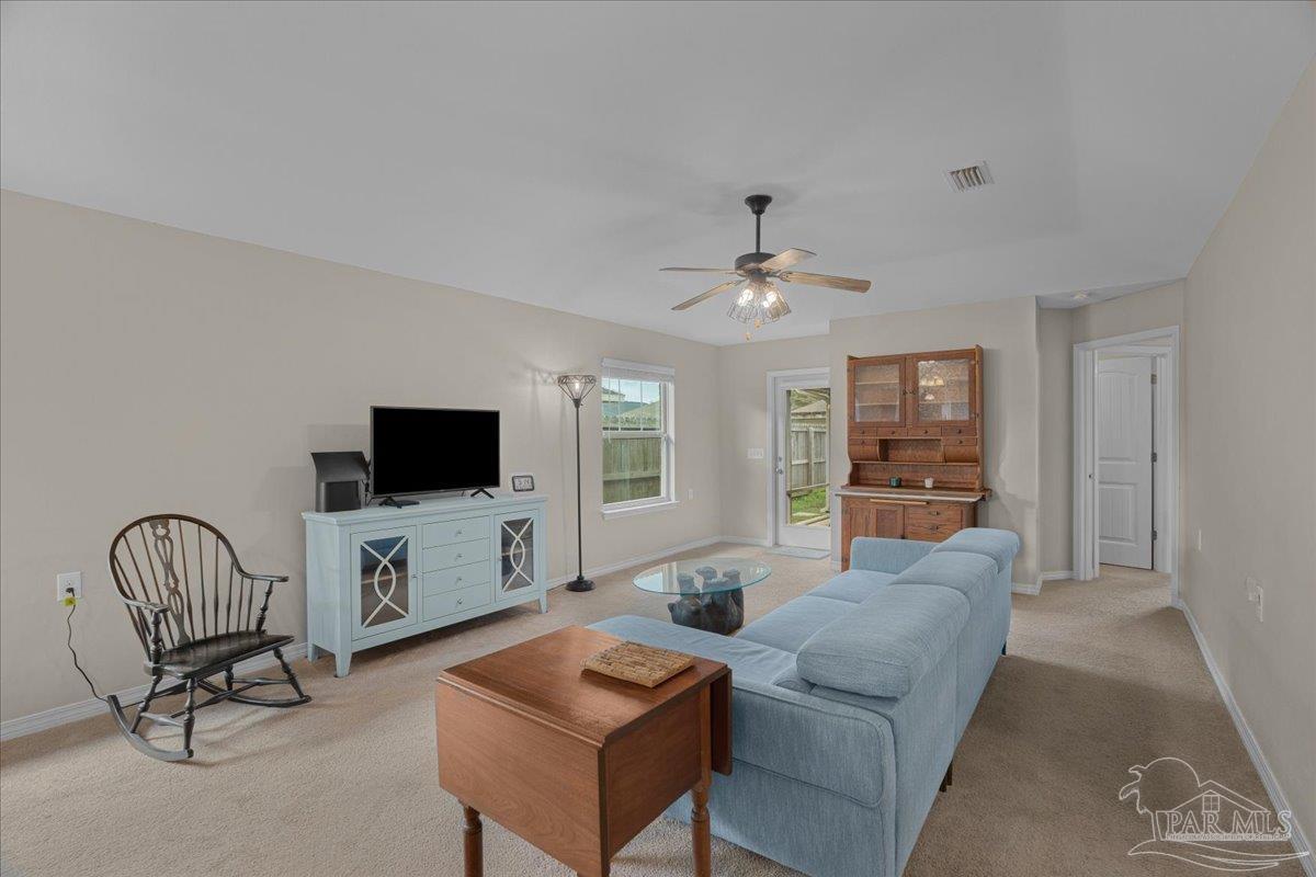 5797 Corkscrew Court Pace, FL 32571 - Photo 21 of 43 a living room with furniture and a flat screen tv