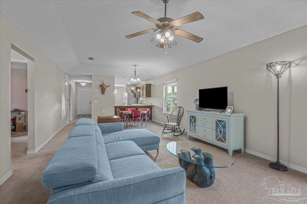 5797 Corkscrew Court Pace, FL 32571 - Photo 23 of 43 a living room with furniture and a flat screen tv
