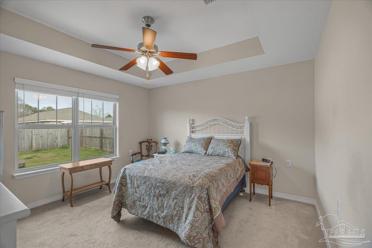 5797 Corkscrew Court Pace, FL 32571 - Photo 25 of 43 a bedroom with a bed and a large window