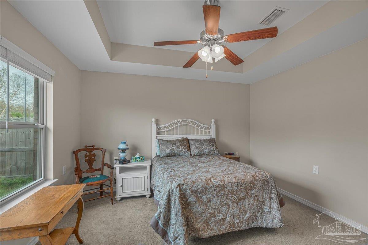5797 Corkscrew Court Pace, FL 32571 - Photo 26 of 43 a bedroom with a bed and wooden floor