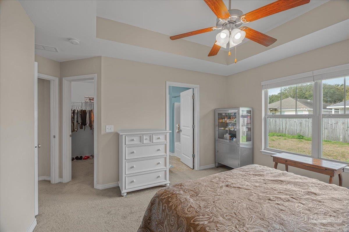5797 Corkscrew Court Pace, FL 32571 - Photo 27 of 43 a bedroom with a bed dresser and a large window