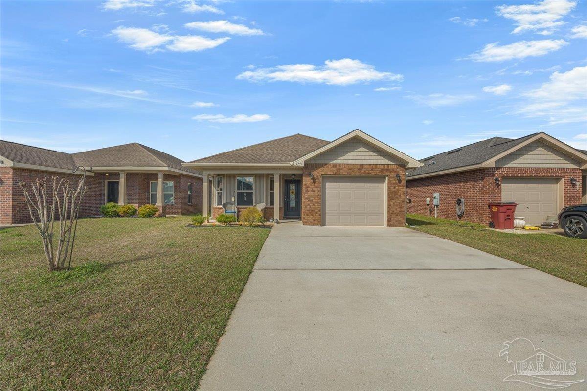 5797 Corkscrew Court Pace, FL 32571 - Photo 3 of 43 a view of house with a garden