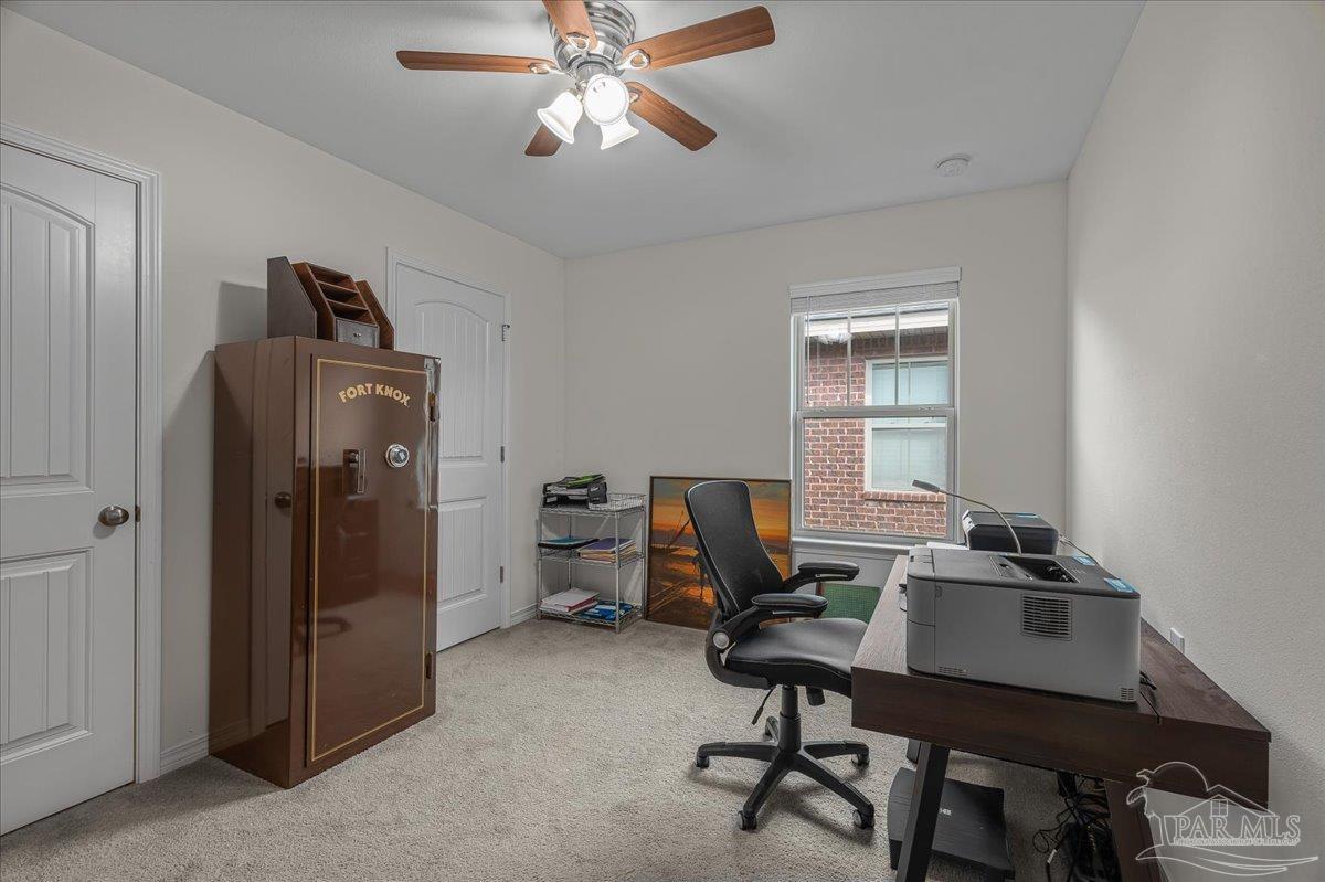 5797 Corkscrew Court Pace, FL 32571 - Photo 31 of 43 a view of a workspace with furniture and a window