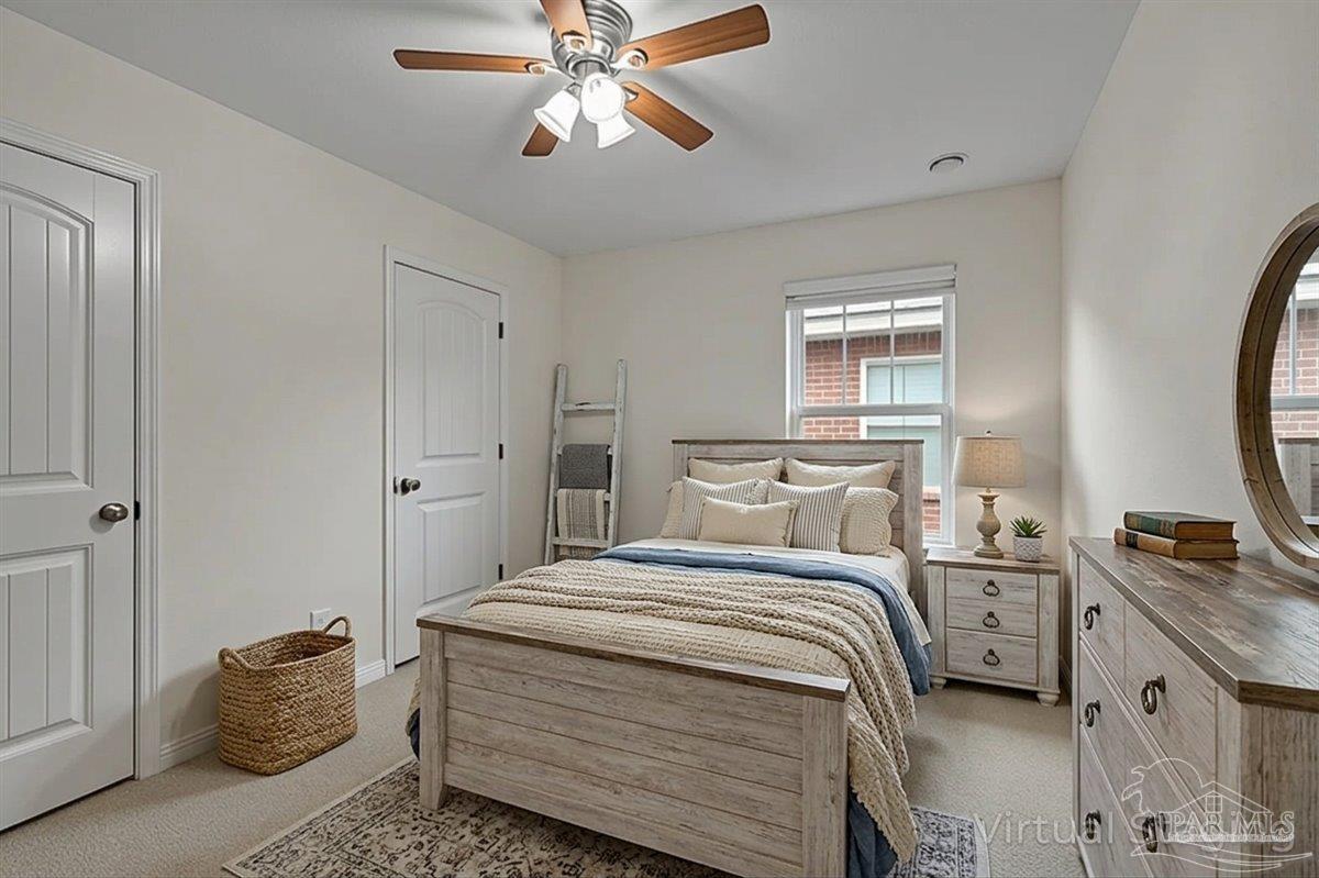 5797 Corkscrew Court Pace, FL 32571 - Photo 32 of 43 a bedroom with a bed and a chandelier