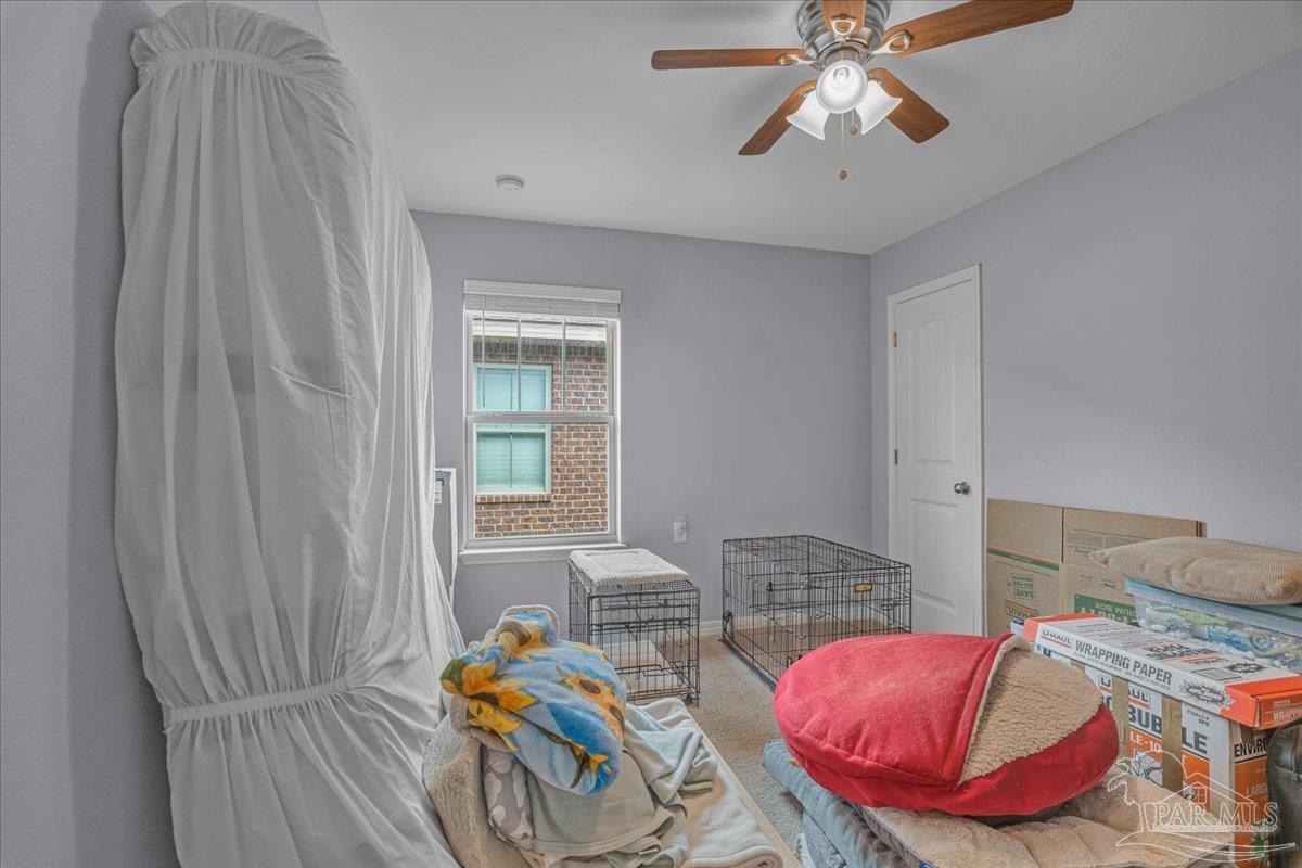 5797 Corkscrew Court Pace, FL 32571 - Photo 35 of 43 a bedroom with a bed and a chandelier