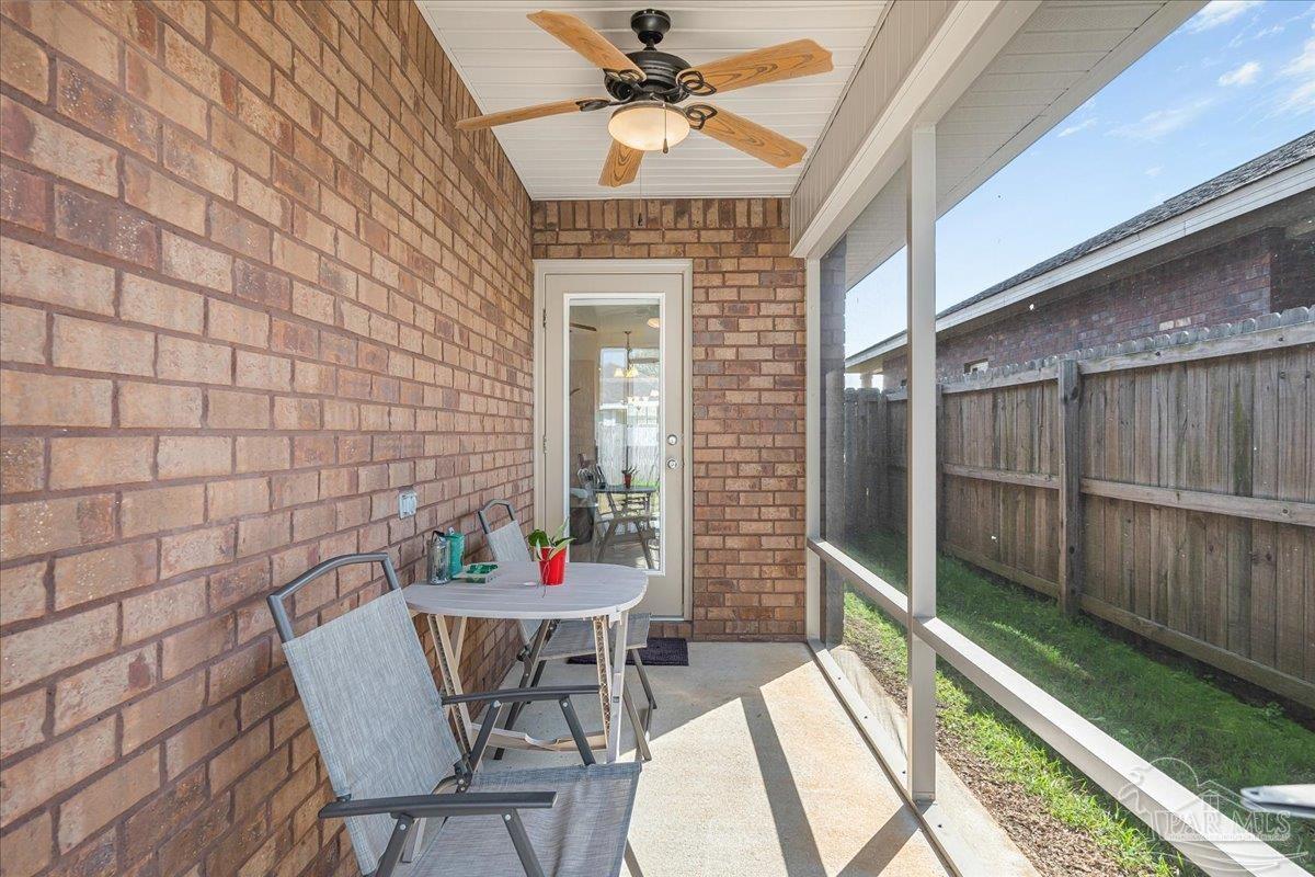 5797 Corkscrew Court Pace, FL 32571 - Photo 38 of 43 a balcony with table and chairs