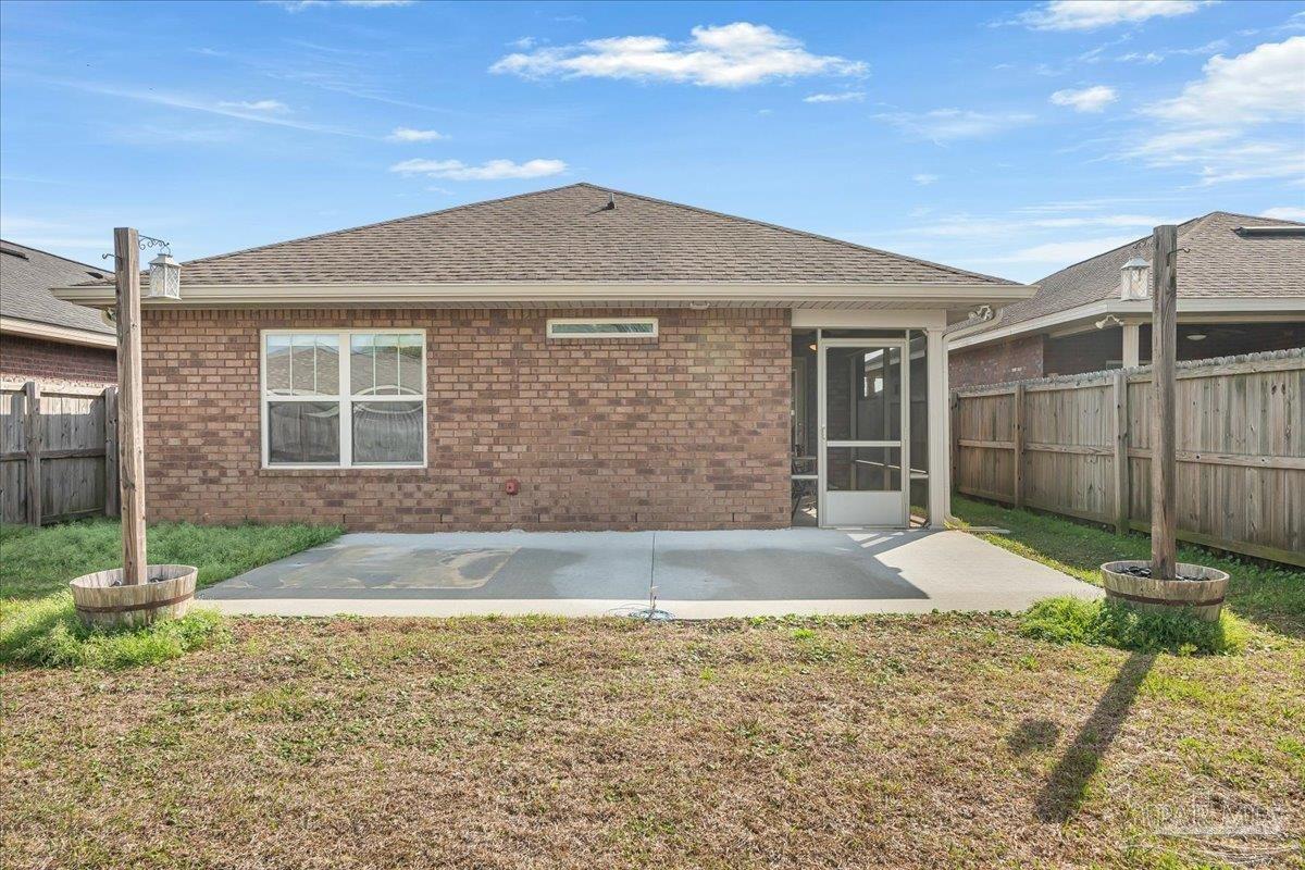 5797 Corkscrew Court Pace, FL 32571 - Photo 39 of 43 a front view of a house with garden
