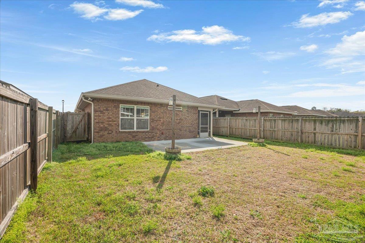 5797 Corkscrew Court Pace, FL 32571 - Photo 40 of 43 a swimming pool with wooden fence