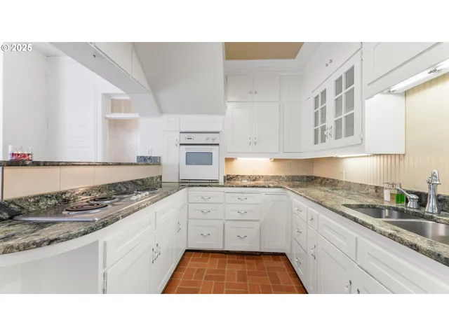 a kitchen with stainless steel appliances granite countertop a sink and cabinets