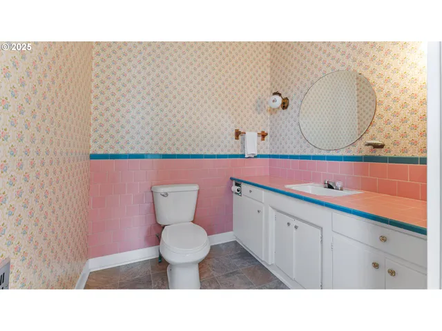 a bathroom with a sink mirror and toilet