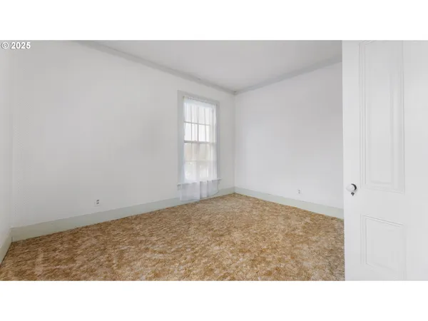 a room with a bed and a window