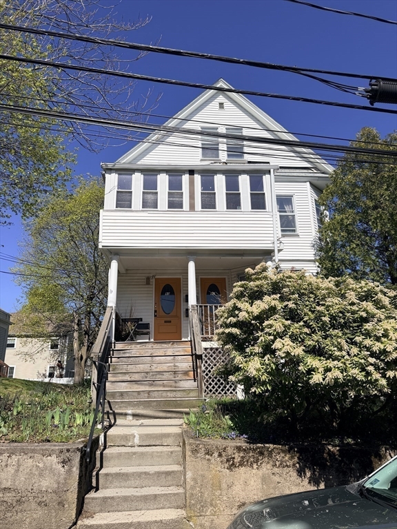 91 Academy Hill Road, Unit 91 Boston, MA 02135 - Photo 13 of 15 a front view of a house with a garden