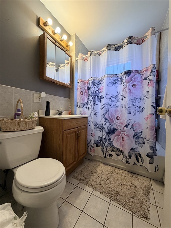 91 Academy Hill Road, Unit 91 Boston, MA 02135 - Photo 15 of 15 a bathroom with a toilet sink and mirror