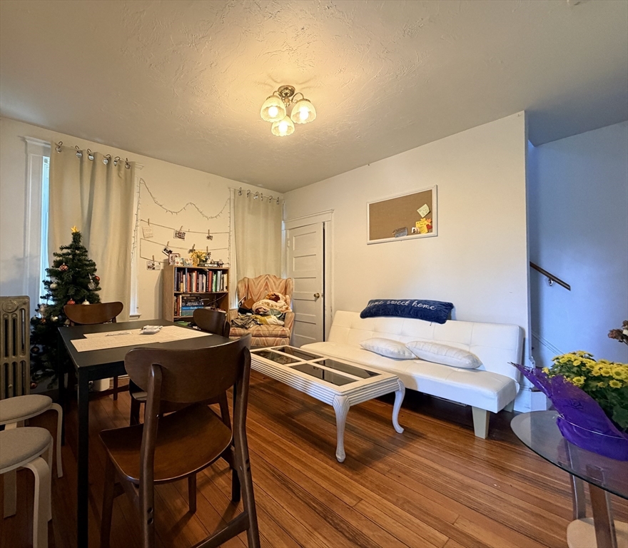91 Academy Hill Road, Unit 91 Boston, MA 02135 - Photo 3 of 15 a living room with furniture and wooden floor