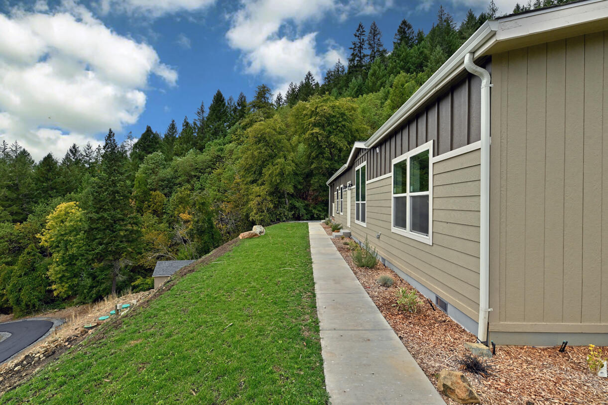 5572 Jumpoff Joe Creek Road Grants Pass, OR 97526 - Photo 36 of 38 a house view with a backyard