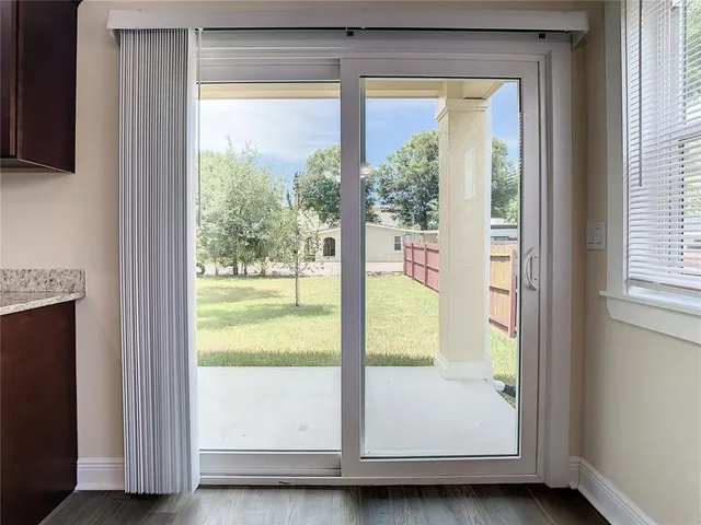 a view of a room with wooden floor and cabinet