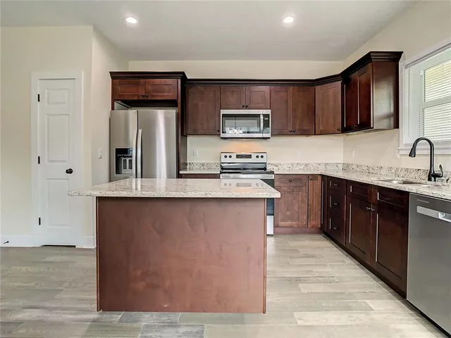 a view of room with window ceiling fan and hardwood floor