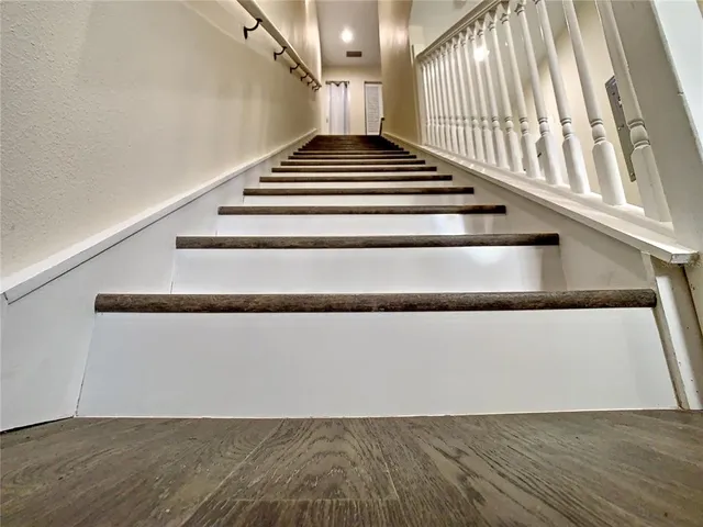 a bathroom with a granite countertop sink vanity and mirror