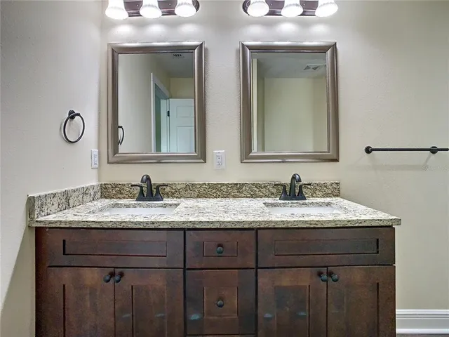 a white toilet sitting next to a bathroom sink