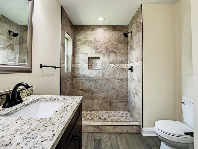 a view of a house with a yard patio and a fire pit