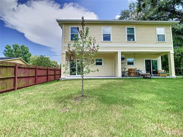 a view of a house with a backyard