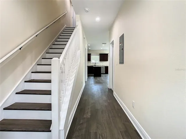a view of entryway and hall with wooden floor