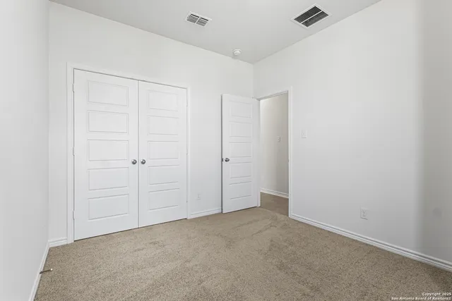 an empty room with closet area
