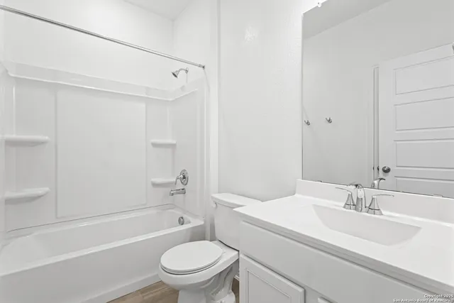 a bathroom with a sink toilet vanity and shower