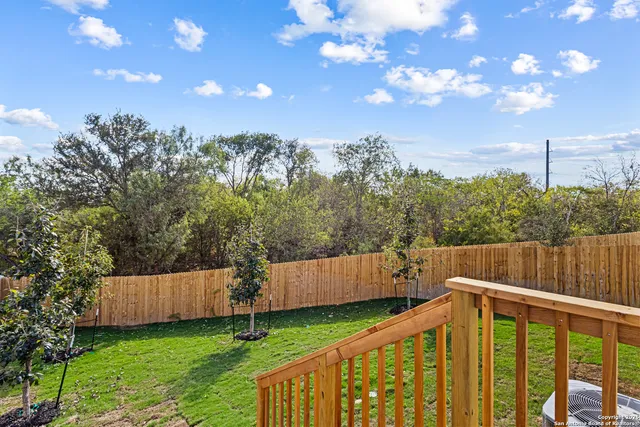 a view of a wooden fence and a yard