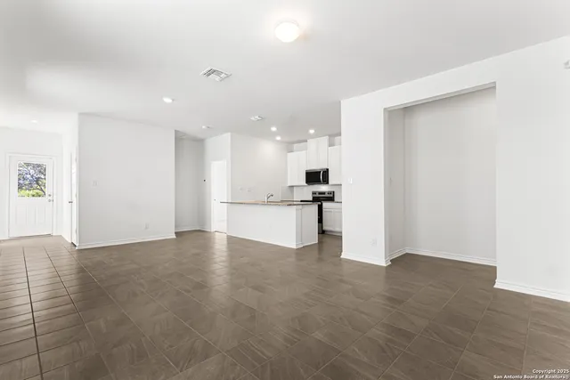 a view of kitchen with kitchen island and stainless steel appliances