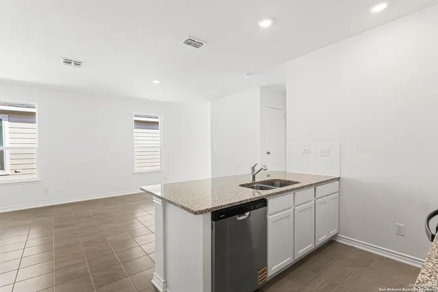 a kitchen with a sink and cabinets
