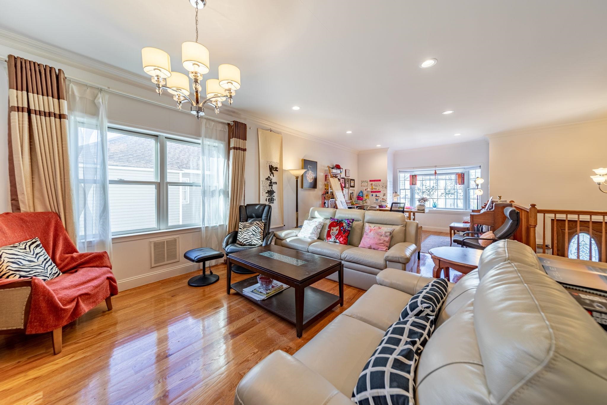 826 Eighth Street Secaucus, NJ 07094 - Photo 1 of 12 a living room with lots of furniture and a chandelier