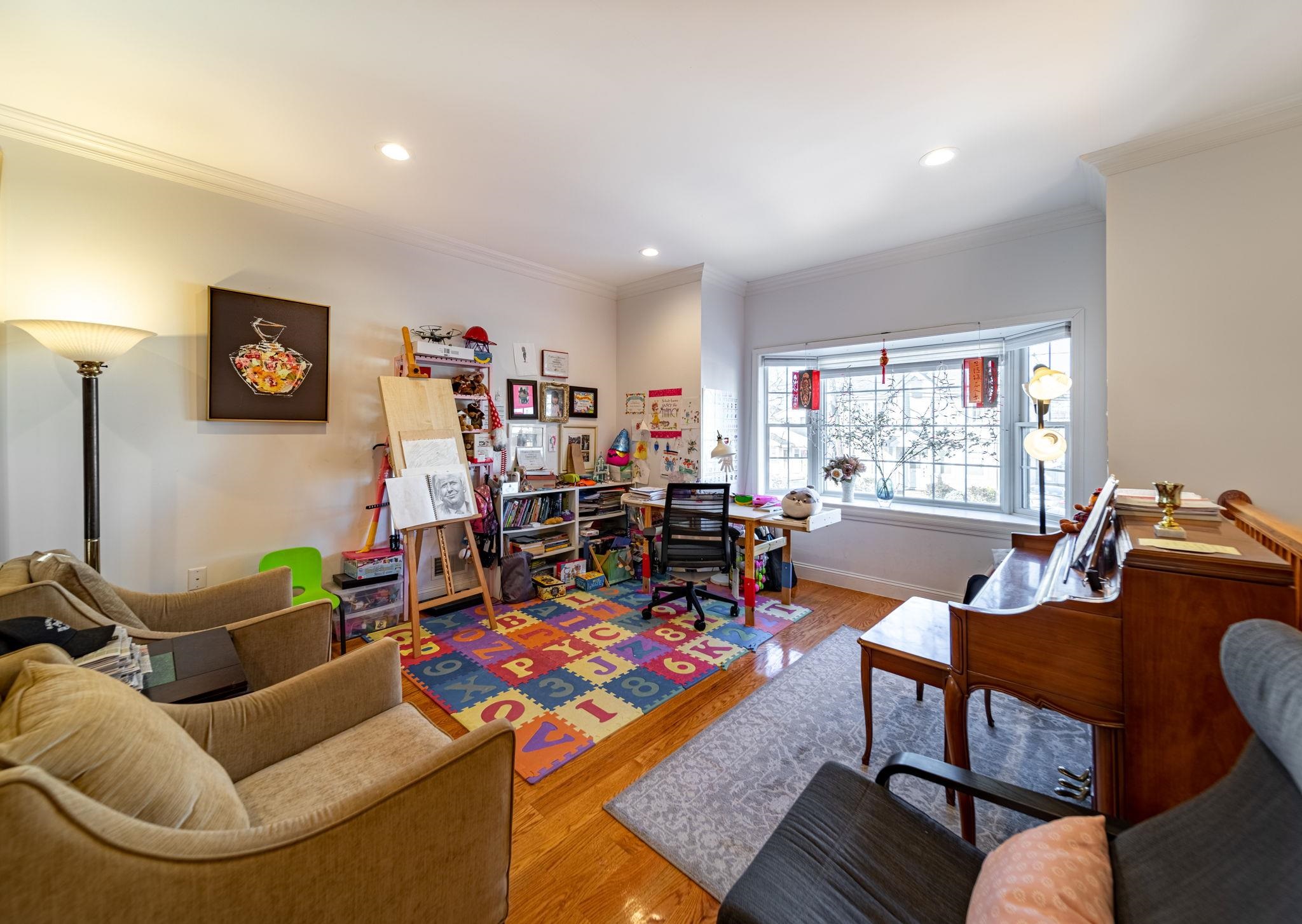 826 Eighth Street Secaucus, NJ 07094 - Photo 2 of 12 a living room with furniture and a flat screen tv