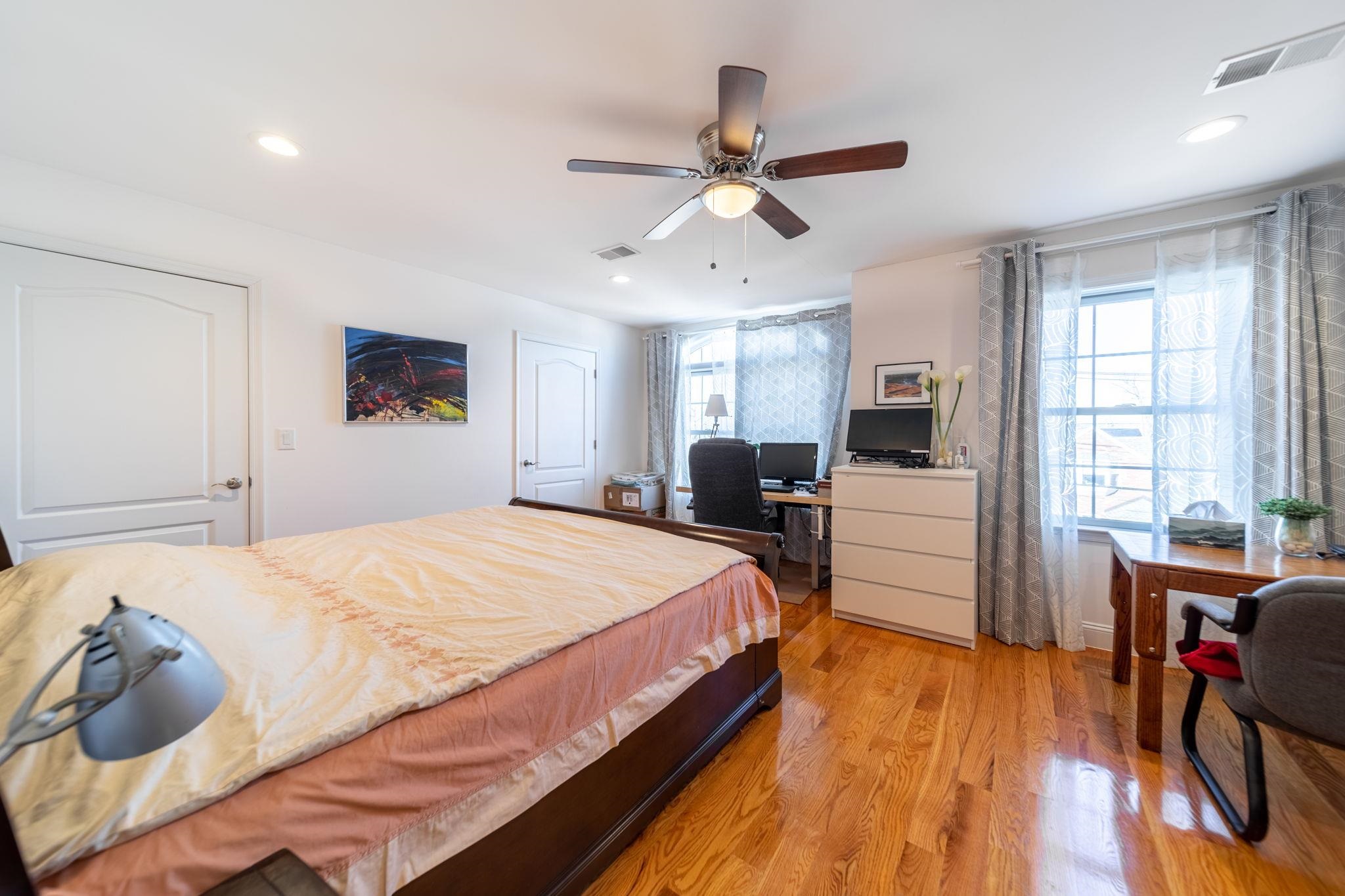 826 Eighth Street Secaucus, NJ 07094 - Photo 5 of 12 a bed room with a bed and a chandelier