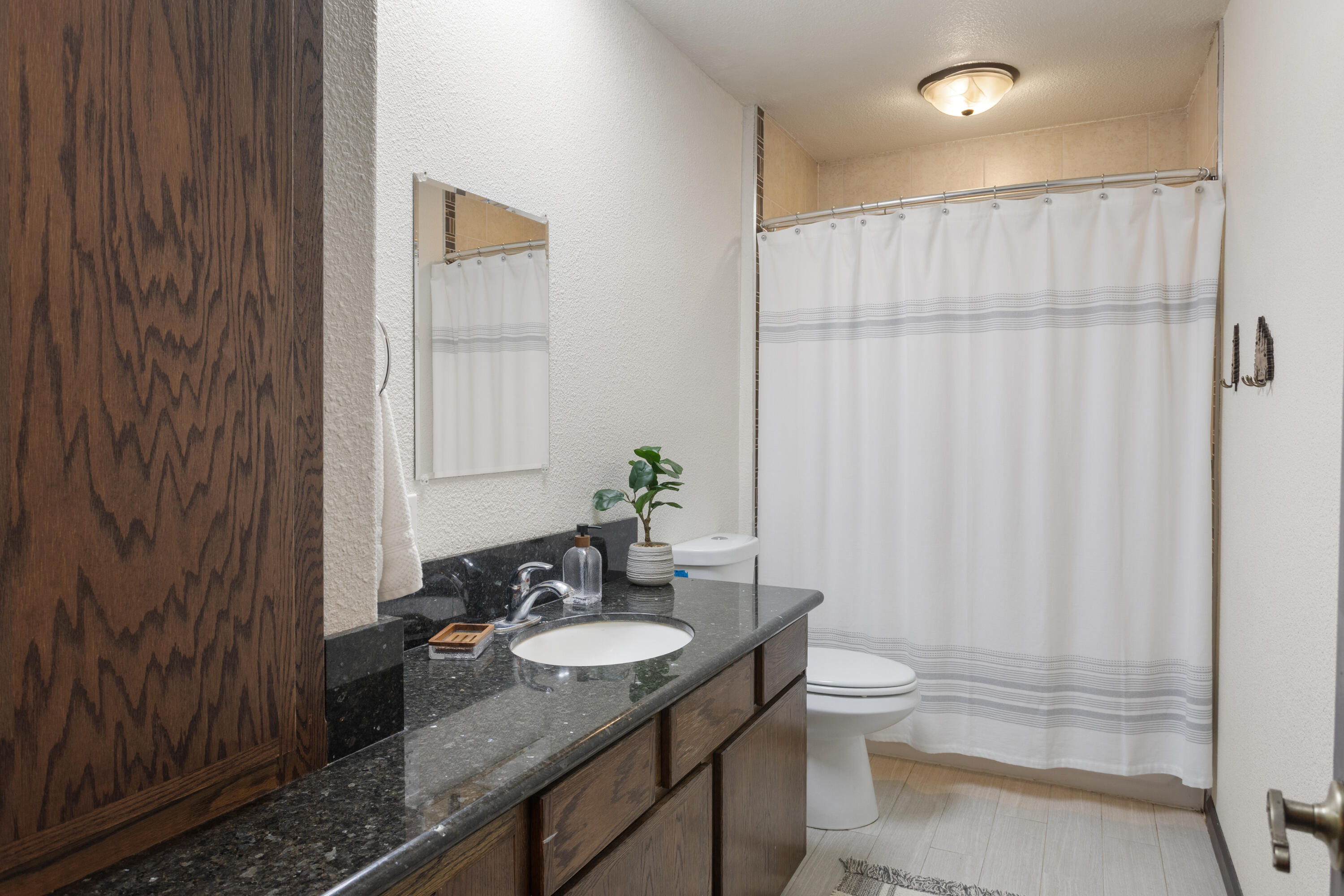 19606 Fish Hill Lane Redding, CA 96003 - Photo 16 of 24 a bathroom with a granite countertop sink toilet and shower