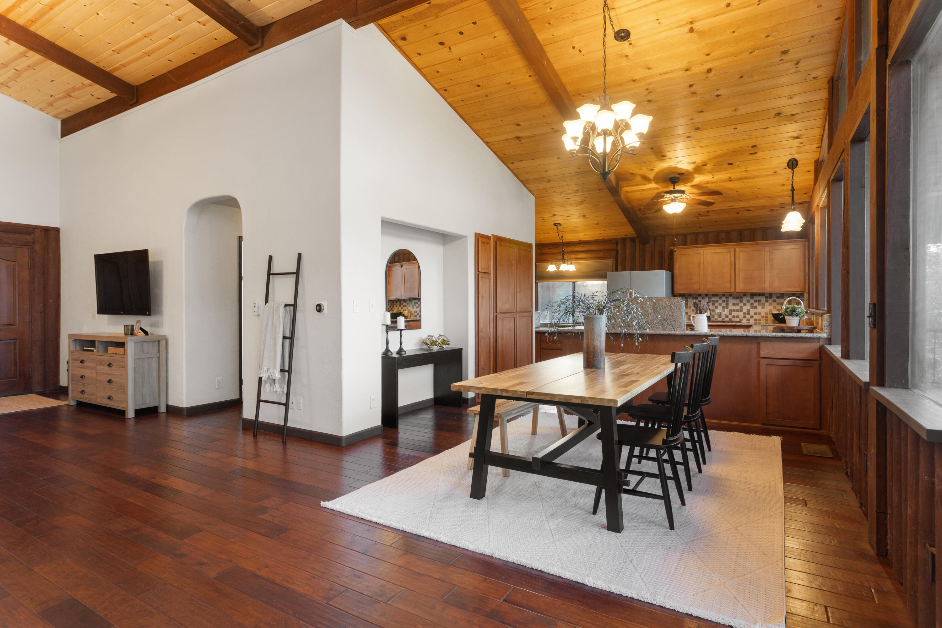 19606 Fish Hill Lane Redding, CA 96003 - Photo 6 of 24 a dining room with furniture a chandelier and wooden floor