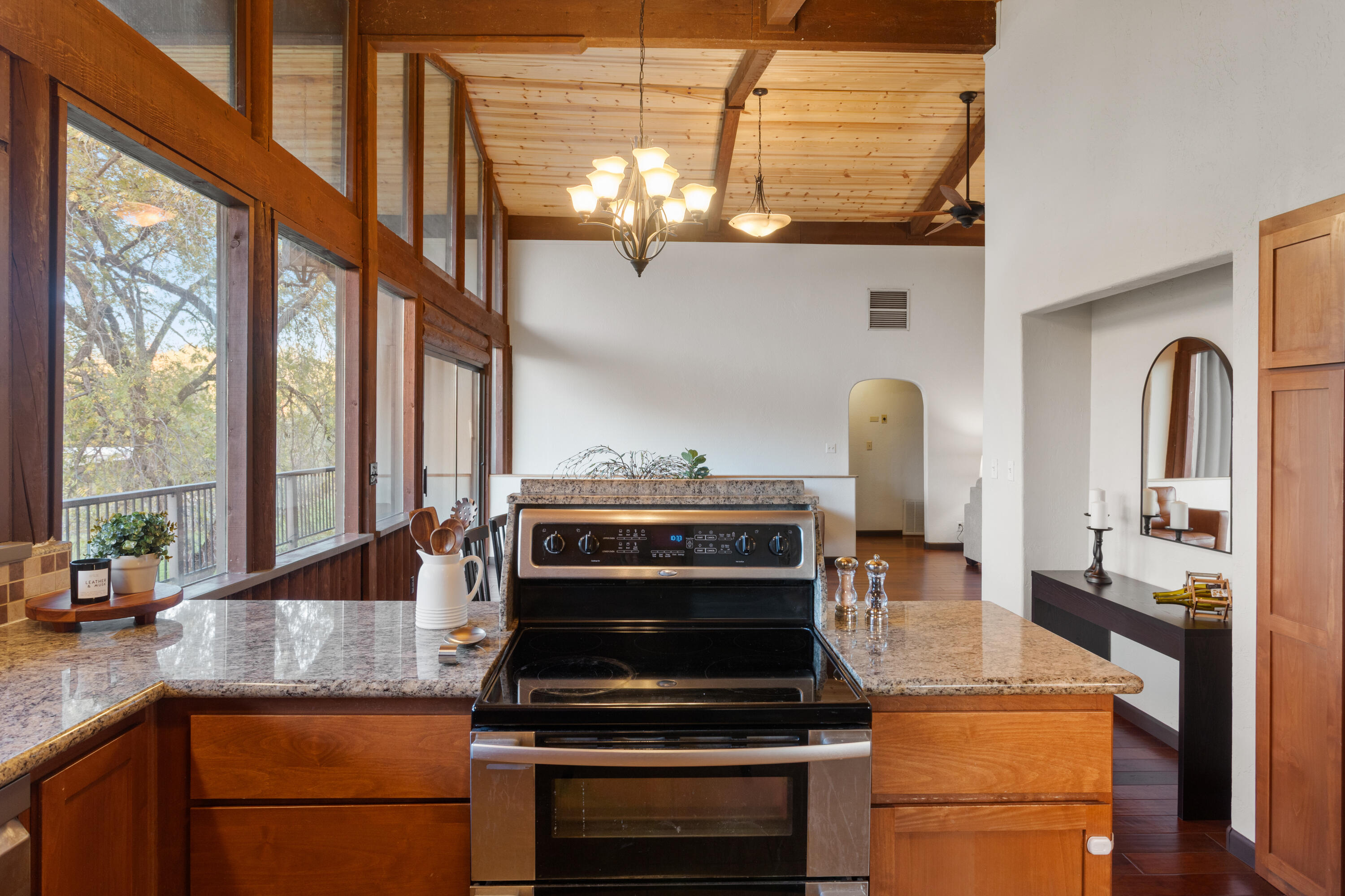 19606 Fish Hill Lane Redding, CA 96003 - Photo 7 of 24 a kitchen with kitchen island granite countertop a stove and a sink