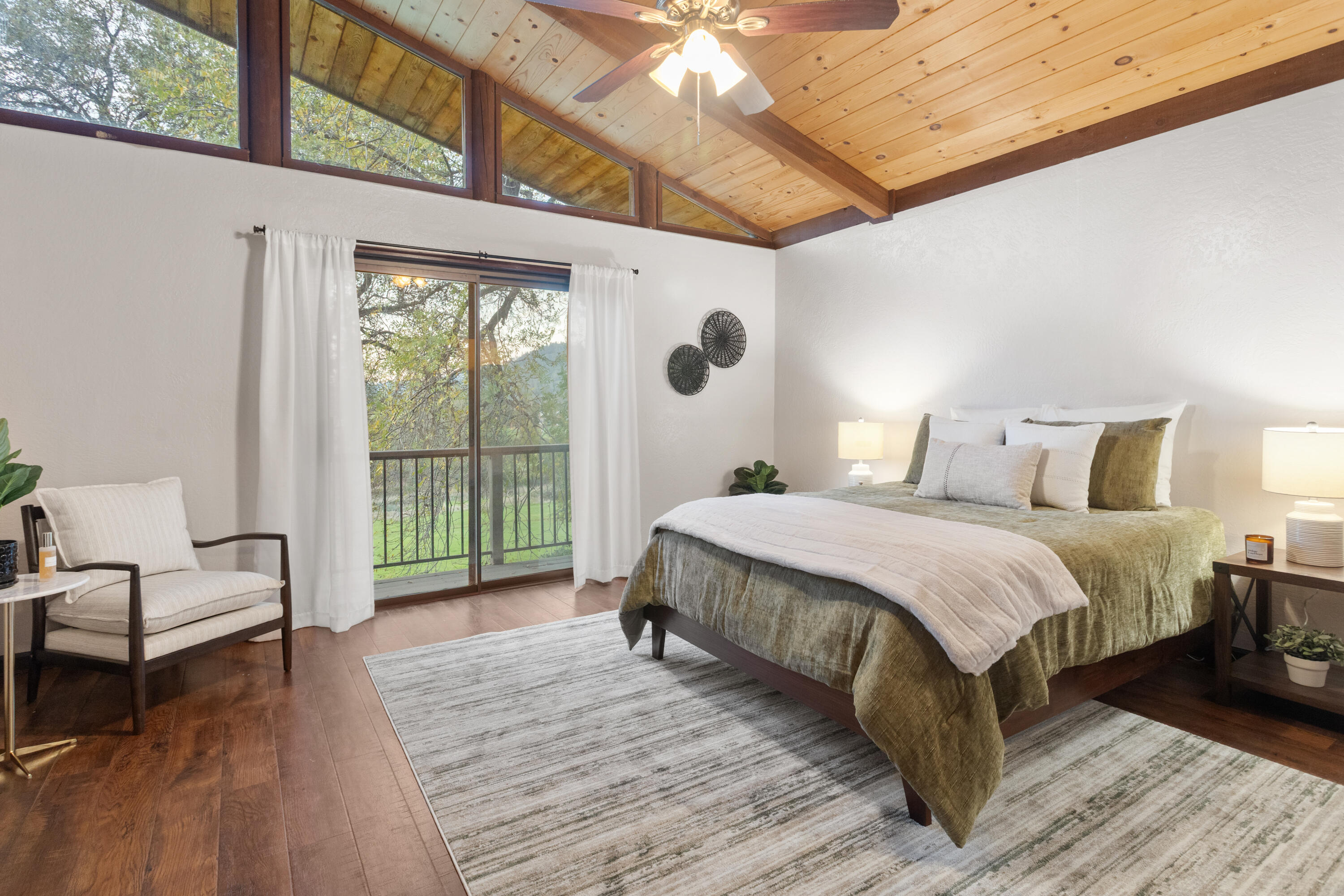 19606 Fish Hill Lane Redding, CA 96003 - Photo 10 of 24 a spacious bedroom with a bed and a large window